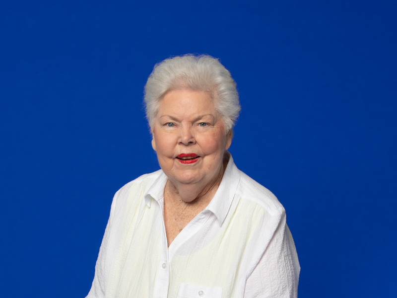 Image of senior lady in white looking at the camera